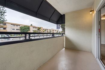 a balcony with a city view and a door to the street